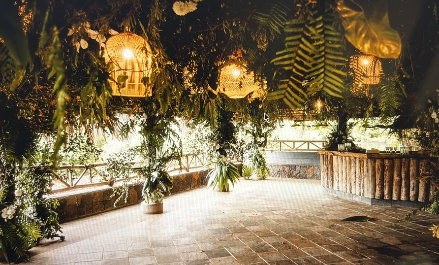 Restored thatched hut filled with tropical flowers and foliage in a remote mountain nature reserve
