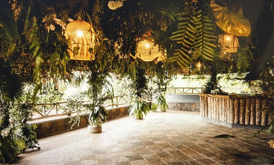 Restored thatched hut filled with tropical flowers and foliage in a remote mountain nature reserve